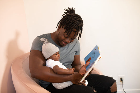 A parent reading to a child before bedtime as a part of their night time routine.